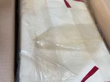 a mattress in a box with a red ribbon on it