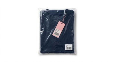 a black t - shirt with a pink tag on it