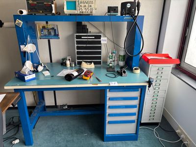 a blue workbench with a computer on top of it
