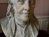 a bust of a man with long hair on a table