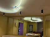 a mirror in the middle of a room with tables and stools