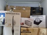 many boxes of kitchen appliances on a shelf in a room