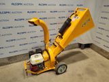 a close up of a small yellow machine on a concrete floor