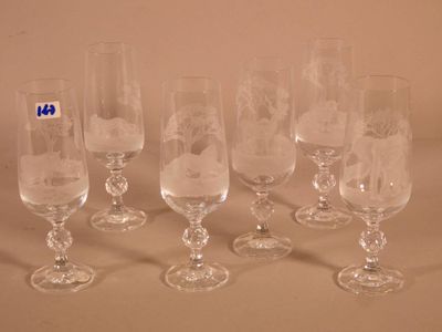 six wine glasses sitting next to each other on a table
