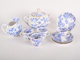 blue and white porcelain tea set with teapot, saucer, cup, and saucer