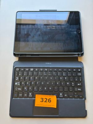 a tablet computer sitting on top of a laptop keyboard