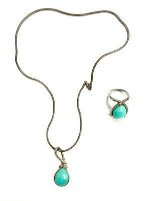 an image of a necklace and earring set on a white background