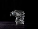 a glass sculpture of an eagle on a table