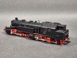 a black and red train engine on a gray surface