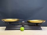 an image of a pair of metal scales with a green apple on top