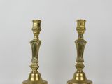 pair of antique brass candlesticks on a white background