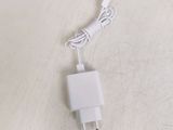 a white charger that is plugged into a wall charger