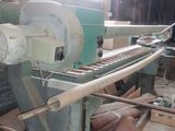 a machine that is working on a piece of wood