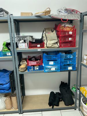 a shelf with baskets and other items on it in a room