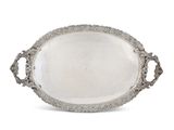 an oval silver tray with handles and handles on a white background