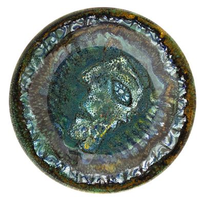 a picture of a close up of a plate with a face on it