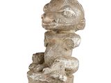 a stone statue of a man holding a dog