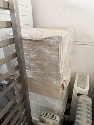 a stack of boxes and a radiator in a room