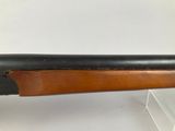 a close up of a rifle on display on a white surface