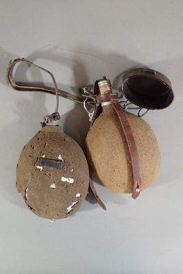 two bottles of wine and a bottle opener hanging from a hook