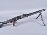 a close up of a toy gun on a stand on a white surface