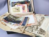 a suitcase full of old photos on a table