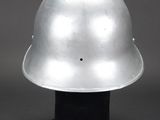a close up of a silver helmet on a black base