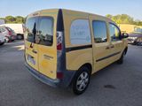 a yellow van that is parked in a parking lot