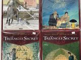 four books of the triangle secret series are on a table