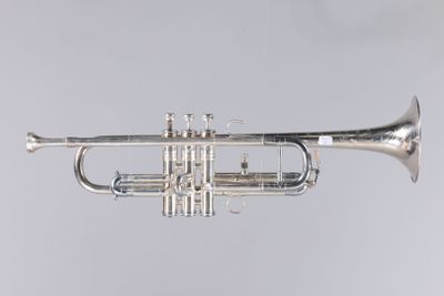 a silver trumpet on a gray background with a white background