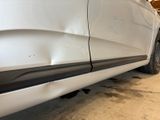 a car that has been dented and is parked in a garage