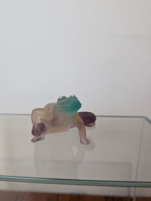 a glass table with a toy animal on top of it
