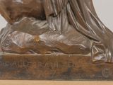 bronze statue of a woman sitting on top of a horse
