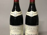 two bottles of wine sitting next to each other on a table