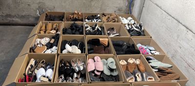 many pairs of shoes in a box on the floor