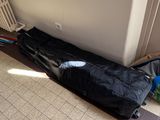 a black bag sitting on the floor next to a radiator