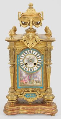 a gold and blue clock with a bird on top of it