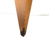 underside view of a wooden table with a piece of wood sticking out of it