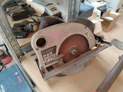someone is using a circular saw to cut a piece of wood