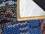 a close up of a quilt with a blue and red design