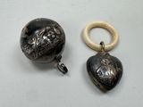 two pieces of jewelry that are on a table