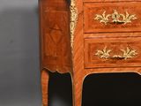 a small wooden chest of drawers with a marble top