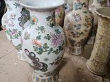 many vases that are sitting on the floor
