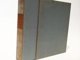 a book that is sitting on a white surface