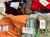 a lot of clothes that are on a bed