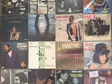 several records are stacked on top of each other on a table