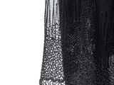 the back of a black dress with sequins and beads on it