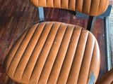two brown chairs sitting next to each other on a wooden floor