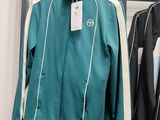 two jackets hanging on a rack in a clothing store