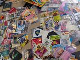 a pile of pokemon cards on a table next to a laptop